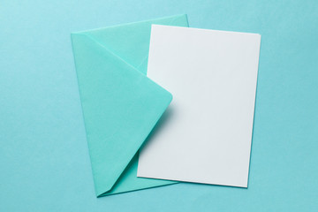 Green envelope and blank letter on green background. Template with place for text on postcard....