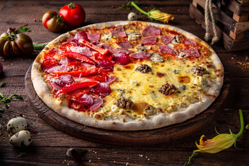 Tasty hot italian pizza Grande Mix with Pizza 4 Cheese, Pepperoni Pizza, Pizza Ham and Mushrooms on old wooden table. Pizzeria menu. Concept poster for Restaurants or pizzerias