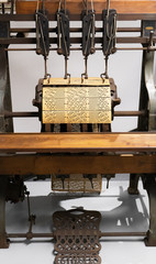 Binding machine. Used to sew together perforated cards for the Jacquard loom.