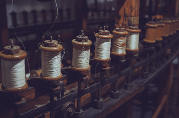 Many white spool of threads in a sewing factory.