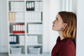 Thoughtful young businesswoman seeking solutions