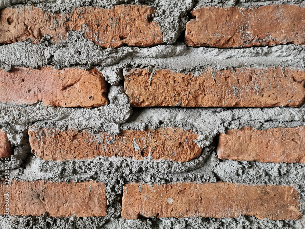 Wall mural orange brick wall surface overlaid with cement