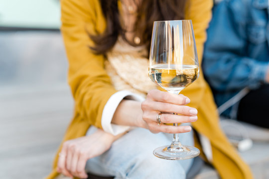 Female Holding Glass Of White Wine