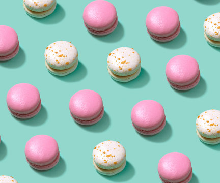 Colorful cake macaron or macaroon on turquoise pastel background from above.