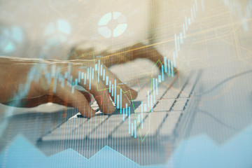 Forex graph with businessman working on computer in office on background. Concept of hardworking. Closeup. Multi exposure.