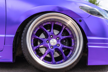 Close up of car wheel with custom disk of tuned low rider sport car