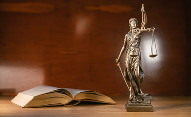 Statue of lady justice on bright background - Side view with copy space.