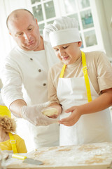 Children cook in the kitchen. Happy child learns to cook in the kitchen delicious chef chef. 