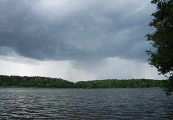 Clouds over the forest lake.