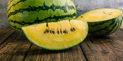 Yellow watermelon on wooden background
