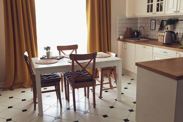 Fototapeta na wymiar Modern Scandinavian style kitchen with dining table