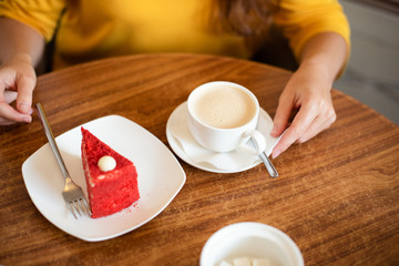 coffee and dessert on the table in a cafe. woman at a table in a cafe