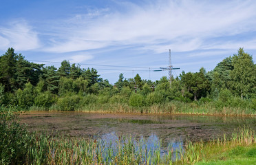 Power Lines: View to the hidden small cable terminal between the overhead high-voltage direct-current transmission line and the ground and sea cables of Konti-Skan 1 and 2 in Oesterby on Laesoe island