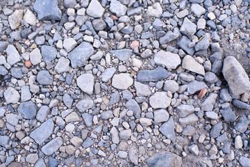 Ground stone gray background of a large number of small stones
