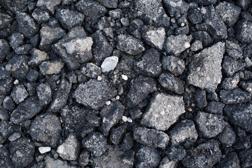 Pieces of asphalt pavement in the hole in the road
