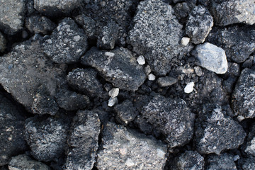 Pieces of asphalt pavement in the hole in the road
