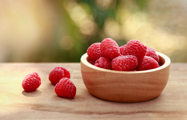 Wooden bowl of raspberry for healthy eating 