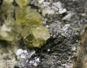 Natural, gently yellow Citrine mineral surrounded by Antimony