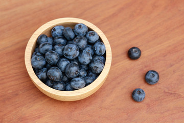Blueberry fruit on wooden bowl for healthy eating 