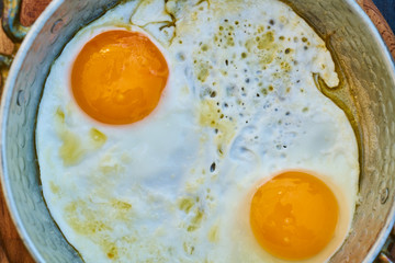 two yellow eggs in pan