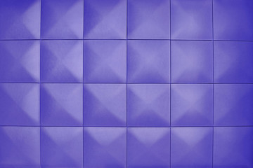 Unusual, beautiful and modern background. Rhombic violet color wall of big squares. Background consists of large purple squares.