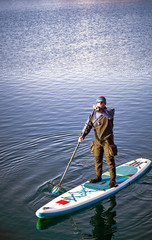 Swimming on the board on the water in the open air.