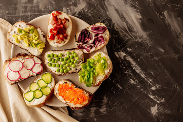 Brushetta or traditional spanish tapas. Appetizers italian antipasti snacks set on wooden board. Top view and flat lay with space for your text
