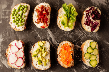 Brushetta or traditional spanish tapas. Appetizers italian antipasti snacks set on wooden board. Top view and flat lay with space for your text