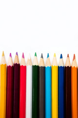 colored pencils empty notebook, top view, space for text