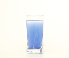 Glass of blue liquid on white background, São Paulo, Brazil