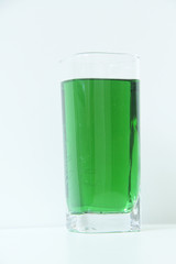 Glass of green liquid on white background, São Paulo, Brazil