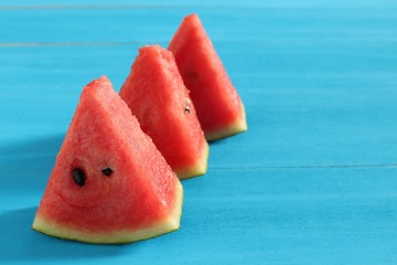  pieces of fresh watermelon on blue wooden background