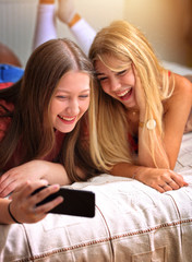 two young girls are taking a selfie
