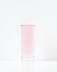 Glass of rose liquid on white background, São Paulo, Brazil