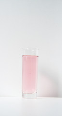 Glass of rose liquid on white background, São Paulo, Brazil