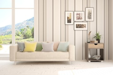 Stylish room in white color with sofa and summer landscape in window. Scandinavian interior design. 3D illustration