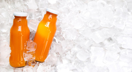 Detox refreshing orange drink in glass bottle on ice