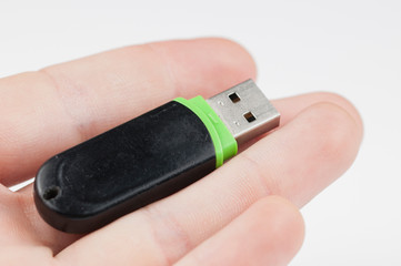 Black usb flash memory in hand isolated on white background.