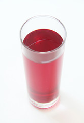 Glass of red liquid on white background, São Paulo, Brazil