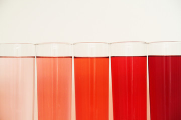 Five glasses of red liquid on white background, São Paulo, Brazil