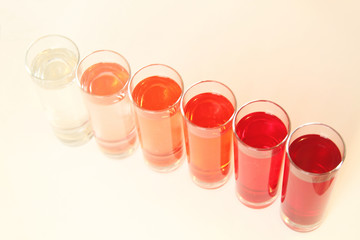 Five glasses of red liquid on white background, São Paulo, Brazil