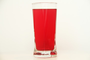 One glass of red  liquid on white background, São Paulo, Brazil