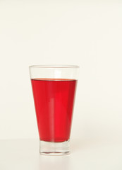One glass of red  liquid on white background, São Paulo, Brazil