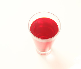 One glass of red  liquid on white background, São Paulo, Brazil