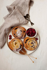 French breakfast with cinnamon rolls and raspberries