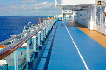 Fototapeta na wymiar Blue treadmill along the deck of a cruise ship for Jogging while sailing.