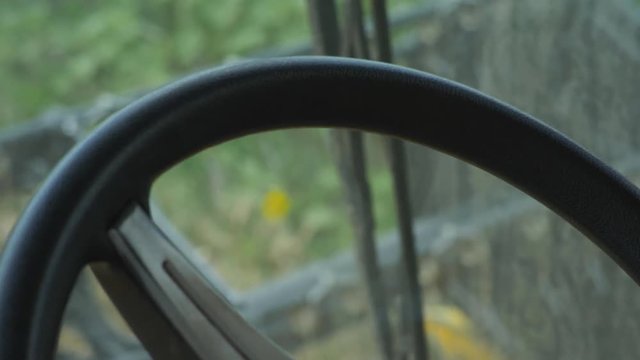 Driving a thresher truck in golden wheat field, close up on driver