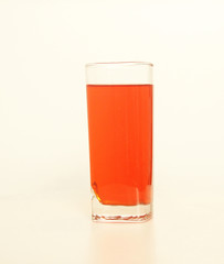 One glass of red and transparent liquid on white background, São Paulo, Brazil