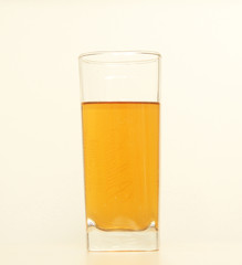 One glass of yellow and transparent liquid on white background, São Paulo, Brazil