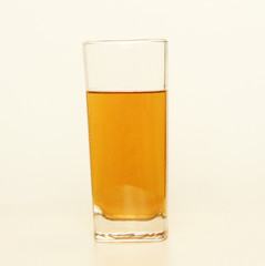 One glass of yellow and transparent liquid on white background, São Paulo, Brazil
